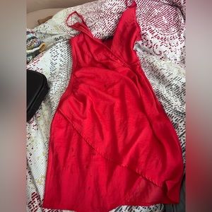 Red satin dress. Has multiple stains which you could probably get out w a wash!